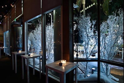 Guests noshed on comfort foods and desserts at white highboys against a wintry backdrop.