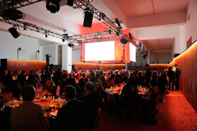 About 7,000 square feet of space was carpeted for dinner. Barriz, the storyteller from the Place Jemaa el-Fna, appeared on large projection screens to signal the start of the meal. To separate the dinner section from the rest of the venue, the producers used a 280-foot-long red moucharabieh wall, which was custom-made for the occasion and transported from Marrakech.