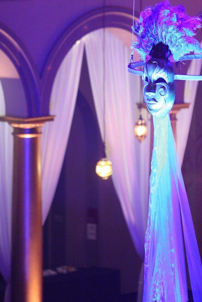 Designers hung Venetian masks with flowing iridescent fabric from the ceiling of the museum.