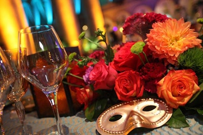 Venetian masks were incorporated into the colorful floral arrangements created by Suzanne Codi Floral Design.