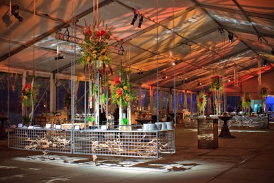 In the cocktail tent, Kehoe's so-called 'caged buffet stations' hung from the roof.