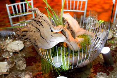 In the dinner tent, each table got centerpieces of metallic bowls filled with grape wood and an assortment of locally grown plants, including sedge and native meadow zizia.