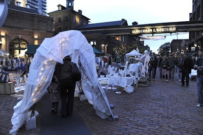 Scotiabank Nuit Blanche attendees walked through a white canopy to enter an installation called 'Way-Station (North Migration)' on Trinity Lane.