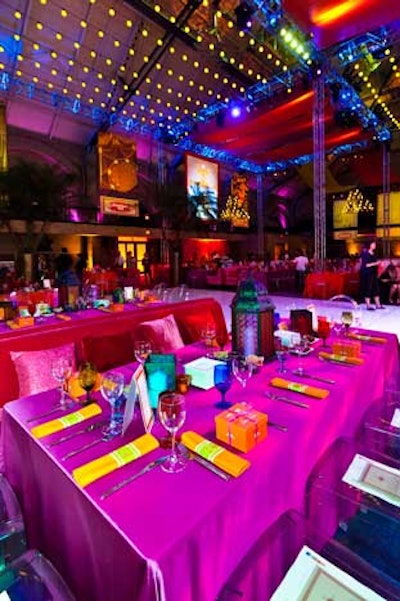 Tabletops were draped in bold-colored linens and glasses, candlelit iron lanterns, and stacks of plates for shareable appetizers.