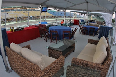 Room Service provided cushioned wicker furniture and dark brown folding chairs for seating in the private Pit Row cabanas.
