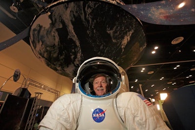 NASA created a photo opportunity at its exhibit booth with a replica of a space suit.