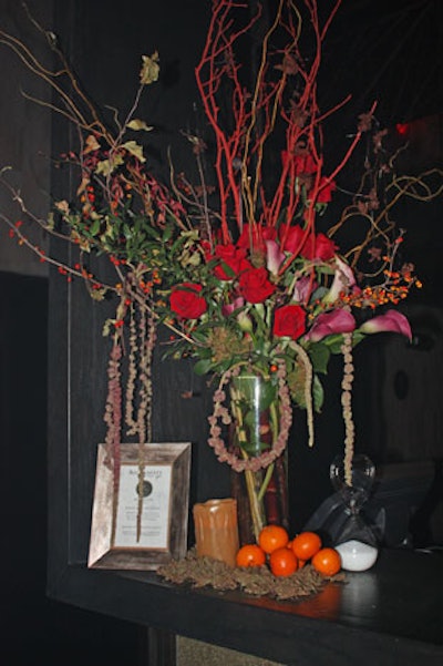 A large deep red, orange, green, and brown floral arrangement adorned the bar.