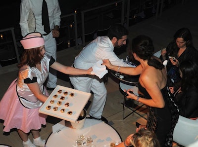 In addition to staffers dressed in simple white uniforms, Great Performances provided servers in kitschy, 1950s-style outfits to pass out snacks like popcorn, cotton candy, and Popsicles before the screening.