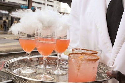 Mixologist Gina Chersevani of Washington restaurant PS7's topped drinks with cotton candy at a Patron-sponsored charity cocktail reception.