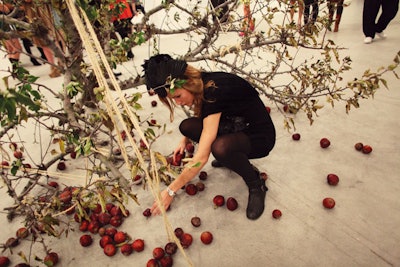 Keeping with the benefit's Adam and Eve theme, Rubell placed small felled apple trees beside piles of cleaned apples for the picking.