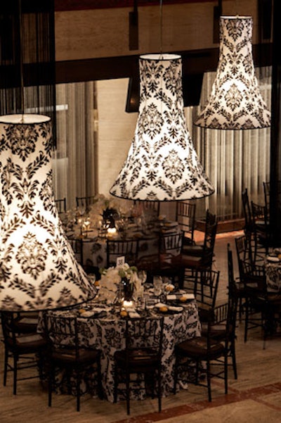 To fill the space between the dinner tables and the soaring ceilings of the grand promenade, Ron Wendt and Philip MacGregor suspended columns of long black fringe and bell-shaped shades.