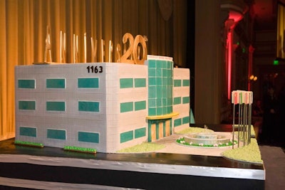 The company's building and surrounding fountain and flags inspired the sculptural cake.