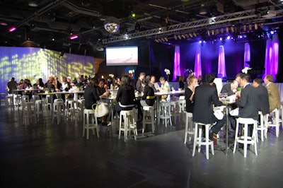 White Charles ghost bar stools surrounded white Plexiglas communal tables in the centre of the room.