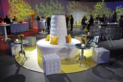 Laurence Heartz of Heartz Event Creation used yellow flowers, pillows, and carpets to accent white furnishings from Contemporary Furniture Rentals.