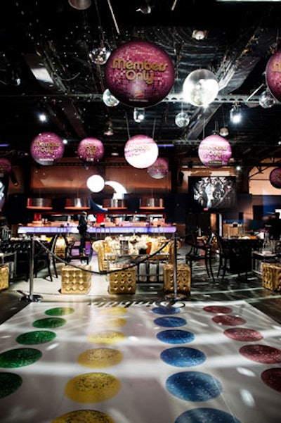 A giant Twister board, with coloured disco balls as the game markings, sat in front of the stage.