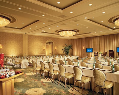 In its natural state, the Four Seasons ballroom has patterned carpeting and wallpaper. For the event, the patterns were hidden behind pony walls and light carpeting.