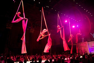 Masquerading as waitstaff, the performers from ImaginAerial jumped onto the stage from the ballroom floor and quickly ascended up strips of hanging fabric.