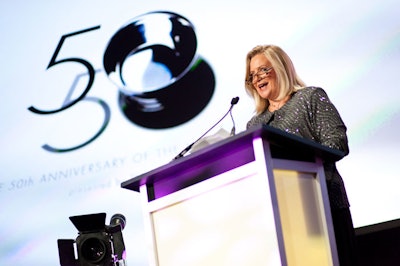 Ad Club president Kathy Kiely took to the stage in front of the group's logo.