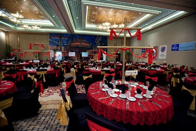 Florida Event Decor created gold ships' masts with red sails to top each dinner table.