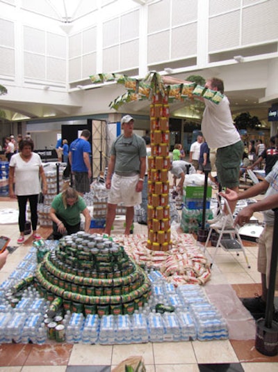 The team from Hunton Brady Architects and M.J. Harris Inc. created a sea turtle and palm tree using water bottles, canned vegetables, jars of peanut butter, and bags of rice.