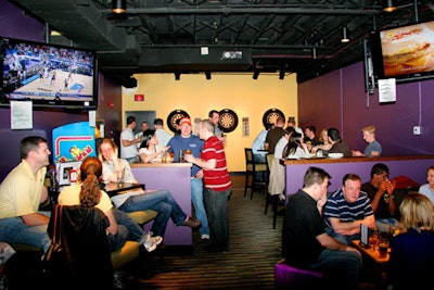 The back lounge is a secluded space for groups, with high-top tables, couches, and five high-definition TVs to watch games.
