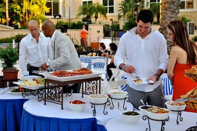 Event staff used blue and white linens to evoke a feeling of the Greek Islands and reflect the Mediterranean theme.