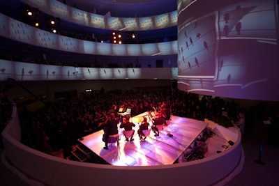 A total of seven live performances representing the winners of YouTube Play took place over two hours in front of an audience of about 1,000 guests, many of whom watched from the Guggenheim's spiraling balconies. Obscura Digital calibrated eight interior projectors to fully cover the surface of the museum's rotunda and create a high-definition main video playback area on a central video column.