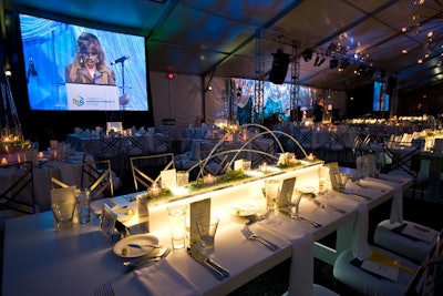 A large screen in the tent broadcast the live auction. Packages included lunch with Mayor Richard Daley and a trip to Vietnam.