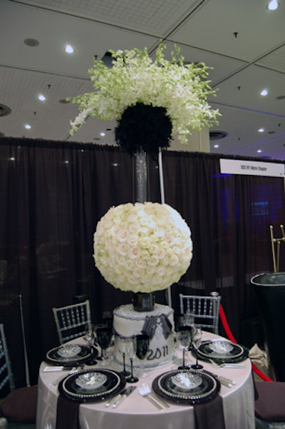 Love and Philanthropy Flowers and Events' tabletop included a glowing New Year's ball centerpiece made of roses, as well as silver and black linens and glassware.
