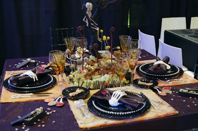 Neuman's Halloween-themed tabletop was full of spooky surprises, including skeleton-hand napkin rings, mini coffins and cauldrons, and a hilltop centerpiece with an old fence and shrubbery.