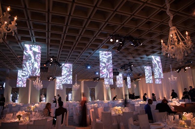 To counter the dinner area's crisp gallery aesthetic, the design team hung chandeliers from the ceiling and Bentley Meeker added custom panels for the projection of video content. The images for the installation from new media artist C.E.B. Reas were designed to be slightly out of focus, creating a more organic look.