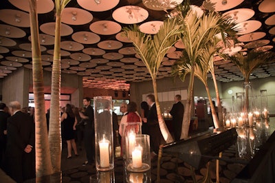 At the Whitney Museum's main entrance and downstairs in the after-party space, Van Wyck & Van Wyck placed a total of 10 palm trees, sprinkled with a mix of areca plants, complemented by large hurricane candles.