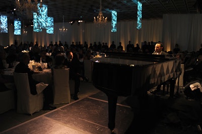 At the front of the room that housed the dinner was a stage, where John Legend performed live with a grand piano.