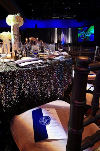 The tables each had several sparkling elements, including underlays of light gray satin with silver sequins sewn into them, and two-tone napkins in silver and charcoal gray that complemented each other.