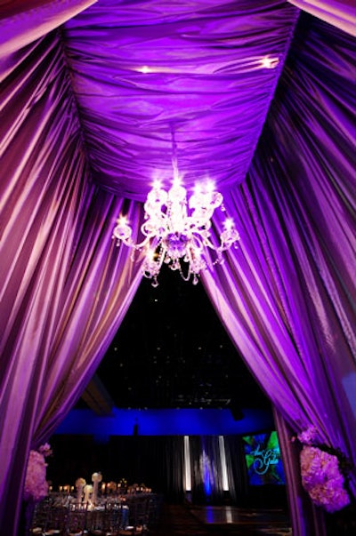 Guests had to walk through one of four tunnels made with silver draping, floral tie-backs, and custom lighting to get from the cocktail reception area to the ballroom.