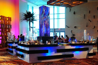 A column in the middle of the bar projected a stained-glass motif onto the walls of the cocktail reception area. It was the same design that Rosina Killian of the school's graphic design department used for the invitations.