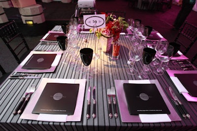 Tabletops, designed by Andrew Anderson of Ilex Designs, featured silver and black linens with pops of red flowers.