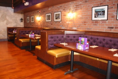 Large semicircular booths with seating for six line two walls in the main dining room.