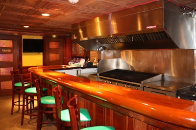 The bar in the back of the second floor has a grill dedicated to charbroiling oysters.