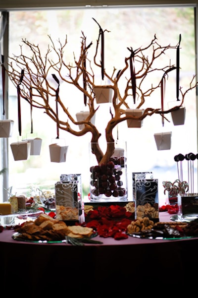 A Manzanita tree centrepiece adorned with hanging boxes suitable for holding sweets is available through Marla Brown Home.