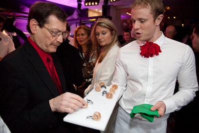 To match the surroundings, Callahan Catering served a number of one-bite hors d'oeuvres on trays decorated with Elbaz's sketches. The menu of sweet, French-inspired bites included miniature sugared donuts (pictured), pink and green cotton candy, and chocolate truffle milk shakes. Croquembouche towers added festive touches to the bars.