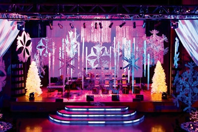 Combining elements of Christmas and Hanukkah, Toronto's Regent Park School of Music staged a Chrismukkah benefit with a modern winter look. McNabb Roick hung oversize snowflakes, stars, and icicles while Westbury National Show Systems lit the room in shades of blue and purple.