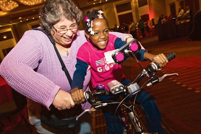 Employees of Astellas Pharma U.S. Inc. teamed up with Total Event Resources to celebrate the season by building 48 bicycles for children from Chicago Youth Centers, a local nonprofit organization. About 40 kids showed up at the end of the event to surprise the company's staffers, who then surprised them with their new bikes.