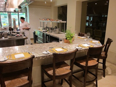 Five guests can dine at the chef's counter, with a view of all the action in the finished kitchen.