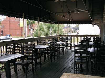 The covered front and side porches at K Restaurant can seat 42, or the tables can be removed to use them as a prefunction area.