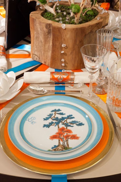 A table helmed by Dennis Duffy Design Group featured a vibrant color scheme, including William Yeoward Avington chargers and Raynaud 'Jardin Celeste' dinner and salad plates, available at Shreve, Crump & Low.