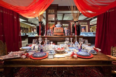 Shreve's visual designer, Eric Steven Jacobs of ESJ Designs, says, 'Why do, when you can overdo?' He created a red-draped table with Mottahedeh 'Blue Canton' china from Shreve's and furniture by Mohr & McPherson.