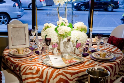 Erin Gates of Elements Interiors (and author of the design blog Elements of Style) incorporated Shreve's gurgling cods and 'Baccarat' goblets on a table ode to her style icons, Martha Stewart and Gwyneth Paltrow among them. An orange zebra-print tablecloth trimmed in deep purple by PMK Designs was the basis for a girly-meets-grand tablsecape with lots of pearls, Lucite-framed place cards, and chairs from PBD Events.