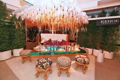 White feathers and amber crystals formed a lavish roof over Kehoe Designs' table, which also incorporated an old-Hollywood-style tufted banquette and mirrored table.