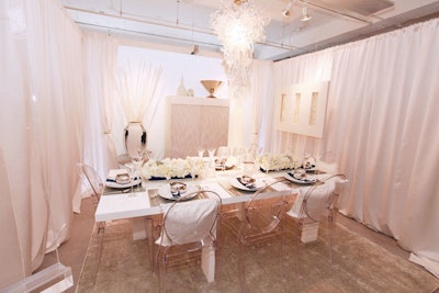 The CS Interiors by Neff of Chicago display had all-white decor. Touches included prop white birds at each place setting and fluffy white pillows on chairs.